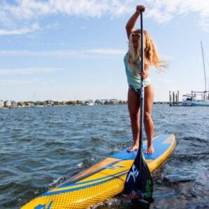 Girl paddling the yellow Hobie Apex race board