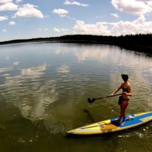 Girl standing on the Hobie Apex SUP on the water