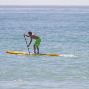 A man paddling the Hobie Apex in the open water