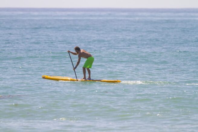 A man paddling the Hobie Apex in the open water