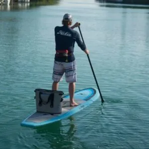 Men with cooler onn the blue Hobie Evalution paddleboard exploring