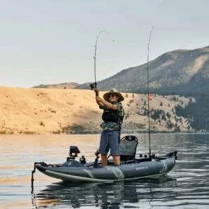 A man standing up fishing in the new 2021 Aquaglide Blackfoot Angler 130 inflatable kayak.