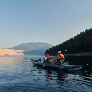 Two fisherman paddling the Aquaglide Blackfoot 160 tandem kayak.