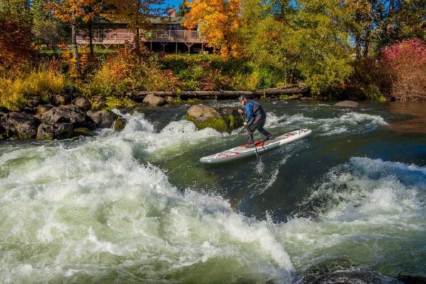 Aquaglide Cascade 12' iSUP with paddler on the river.