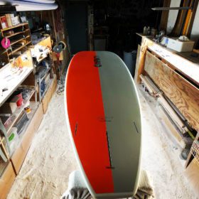 Infinity SUP Wide Aquatic bottom in orange and gray tail view designed by Steve Boehne.