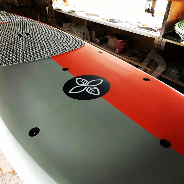Infinity SUP Wide Aquatic deck in orange and gray front view designed by Steve Boehne.