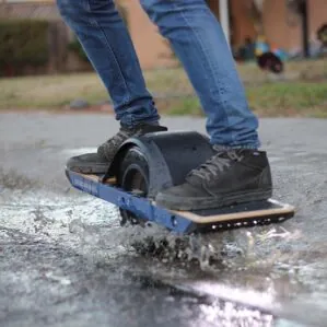 Persone riding the OneWheel through the water image