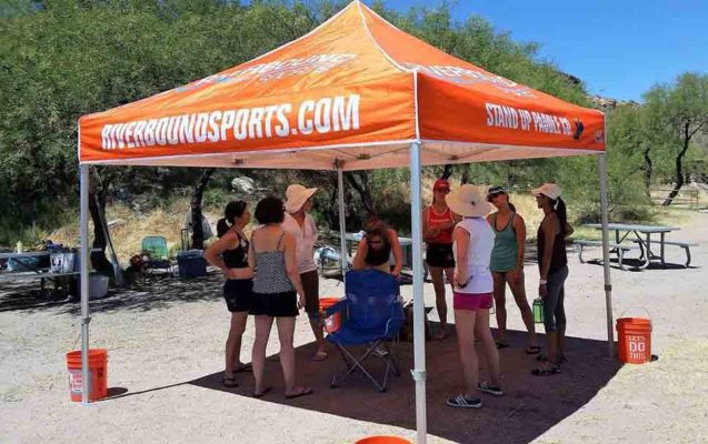Meeting under the Riverbound Sports tent before the Canyon Lake group SUP lesson and paddleboard fitness class with Pam.