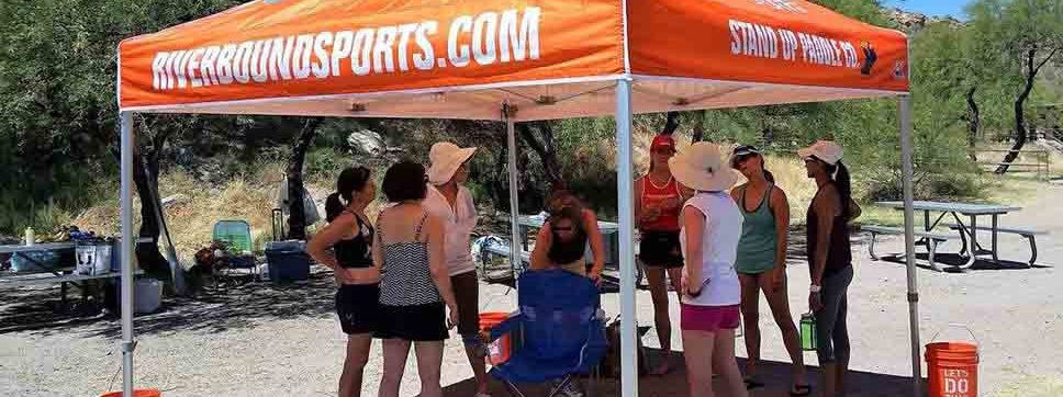 Meeting under the Riverbound Sports tent before the Canyon Lake group SUP lesson and paddleboard fitness class with Pam.