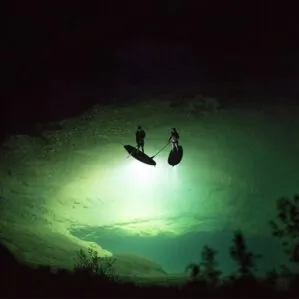 A picture showing two paddlerson the water with the underwater glowing from the JP Australia Outback light in the capsule.