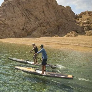 A couple paddlers on the AllWater GT touring paddle boards on the water.