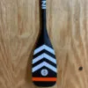 Infinity SUP carbon blade with white and orange strips.