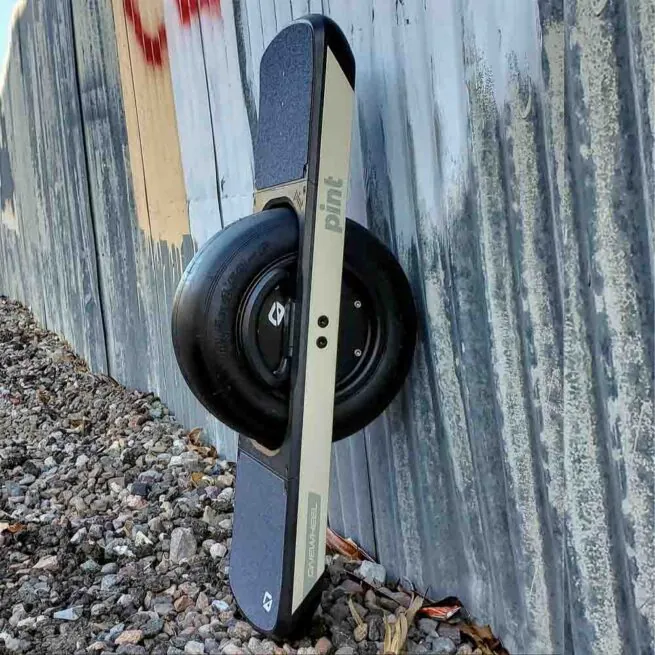 Future Motion OneWheel Pint in sand against a graffiti wall in Tempe, Arizona.