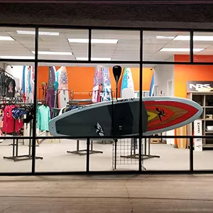 Front of Riverbound Sports Paddle shop with paddleboard in the window.
