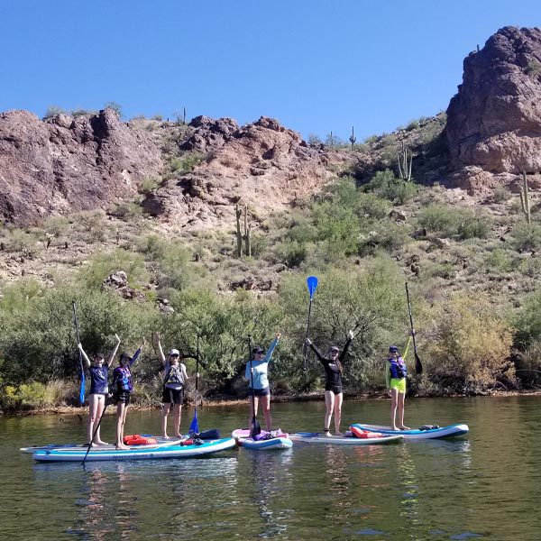 A group Paddle boarding at Saguaro Lake in Arizona with Riverbound Sports.