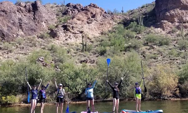 A group Paddle boarding at Saguaro Lake in Arizona with Riverbound Sports.