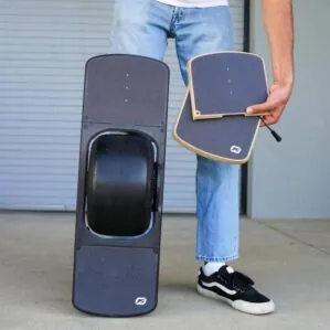 Person holding both front and rear Pint Wood Surestance Footpads by Future Motion.