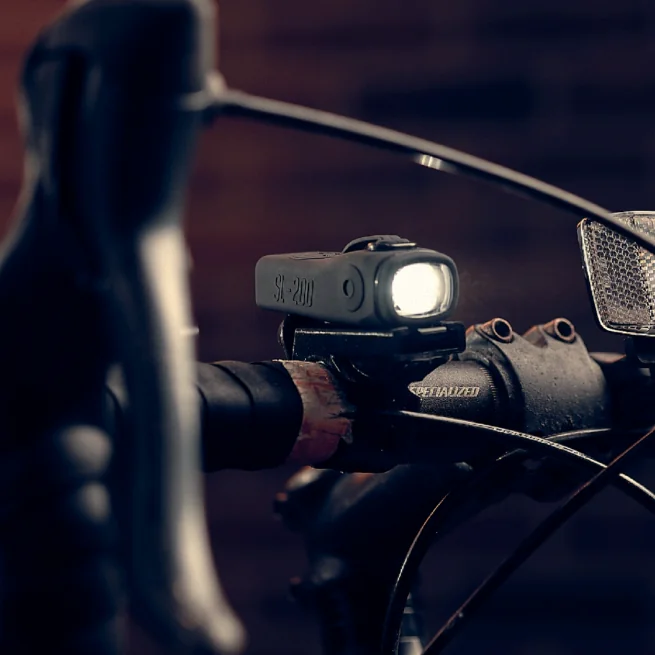 ShredLights white headlight SL200 on the handlebars of a bicycle.