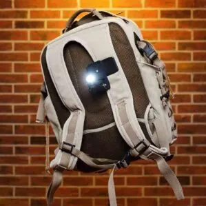 ShredLights Action clip mount with SL-200 white LED light on a backpack.