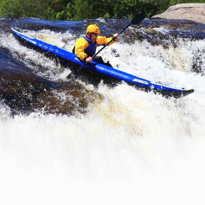 Man whitewater paddling the 380X Sea Eagle inflatable kayak.