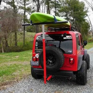 Red Jeep with a paddleboard on the Boonedox Tailbone.