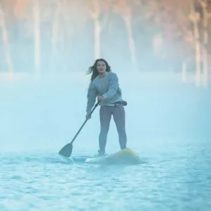 A women paddling the Badfish Wayfarer paddle board in the fog. The Wayfarer is available at Riverbound Sports in Tempe, Arizona.