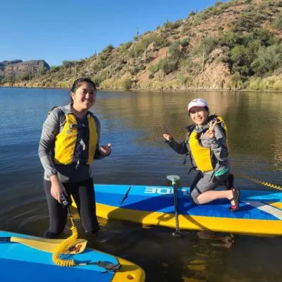 Two ladies at Saguaro Lake learning how to paddleboard. Riverbound Paddle Company SUP Lessons