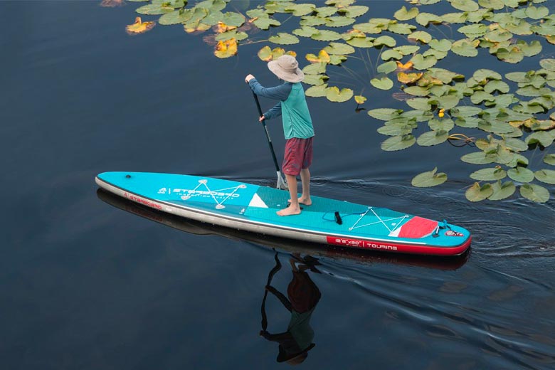 The Starboard Zen touring board being paddled on calm water. Available at Riverbound Sports in Tempe, Arizona.