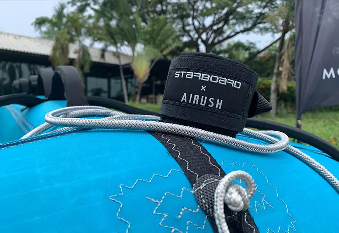 Starboard Feewing in teal leash. Available at Riverbound Sports in Tempe, Arizona.