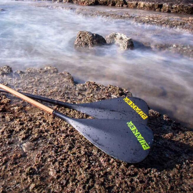 The Puakea Designs Hopu OC6 paddles with a carbon blade with the Puakea logo, and a double-bend shaft. Available at Riverbound Sports in Tempe, Arizona.