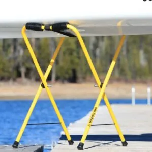 Suspenz Universal stands in yellow with kayak. Available at Riverbound Sports Paddle Company in Tempe, Arizona.