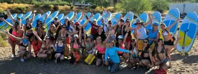 FitWell event. A group of ladies posing with paddleboards at the Lower Salt River.