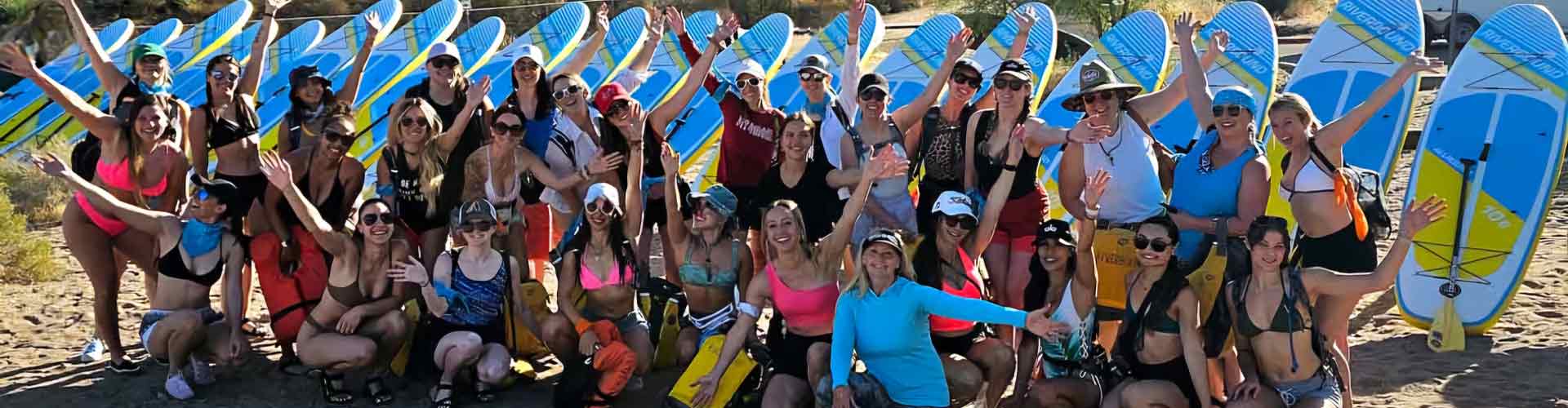 FitWell event. A group of ladies posing with paddleboards at the Lower Salt River.