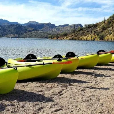 Kayaks lined up at Saguaro lake waiting for a Riverbound Sports Kayaking Tour.