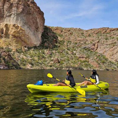 Two people kayaking in scenic desert waters at Canyon Lake. Riverbound Sports Paddle Company