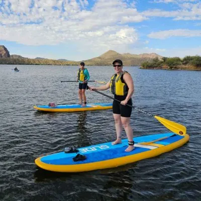 Two ladies on a paddleboarding tour at Saguaro Lake. Riverbound Sports Paddle Company