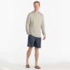 Man in beige hoodie and blue dusk II Free Fly Breeze 8" shorts at Riverbound Sports in Tempe, Arizona.