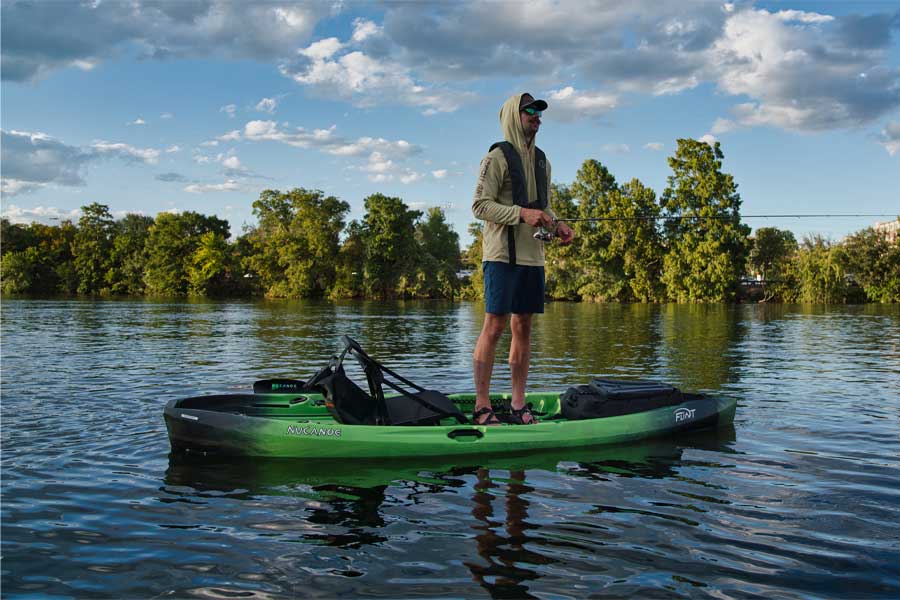 An angler fishing from standing up on the NuCanoe Flint. Available at Riverbound Sports in Tempe, Arizona