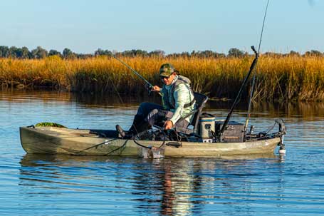 A person fishing from the NuCanoe U10 rigged with motor and gear. Available in Arizone from Riverbound Sports