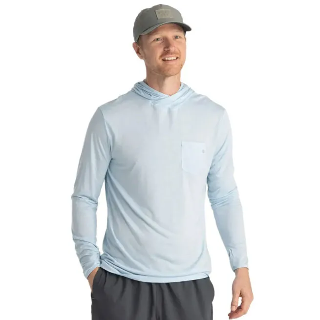 A man wearing the Free Fly Bamboo Long Sleeve Sun Hoody in blue bird color from the front. Available at Riverbound Sports.