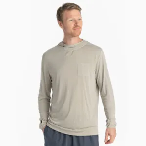 A man wearing the Free Fly Bamboo Long Sleeve Sun Hoody in sandstone color from the front. Available at Riverbound Sports.