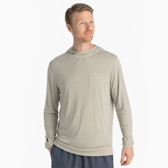 A man wearing the Free Fly Bamboo Long Sleeve Sun Hoody in sandstone color from the front. Available at Riverbound Sports.