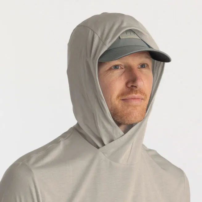 A man showing the hoody of the Free Fly Bamboo Long Sleeve Sun Hoody in sandstone color. Available at Riverbound Sports.