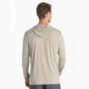 A man wearing the Free Fly Bamboo Long Sleeve Sun Hoody in sandstone color from the back. Available at Riverbound Sports.