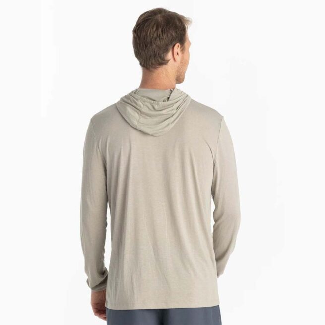 A man wearing the Free Fly Bamboo Long Sleeve Sun Hoody in sandstone color from the back. Available at Riverbound Sports.