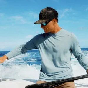 A man on the water wearing the Free Fly Lightweight Bamboo Long Sleeve Sun shirt from Riverbound Sports.