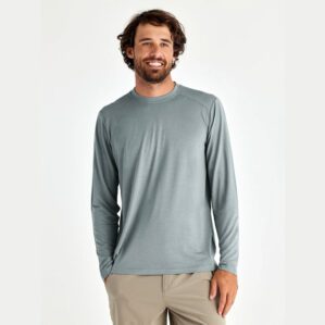 A man wearing the Free Fly Bamboo Long Sleeve Sun Shirt in slate blue from the front. Available at Riverbound Sports.
