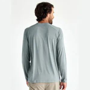 A man wearing the Free Fly Bamboo Long Sleeve Sun Shirt in slate blue from the back. Available at Riverbound Sports.