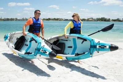 Sea Eagles EZLite10 Inflatable being taken to the water by two paddlers.